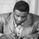 Jackie Robinson signs contract to play for the Brooklyn Dodgers. (Getty)